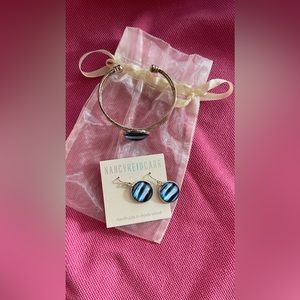 Silver pierced earrings and bracelet set in bag